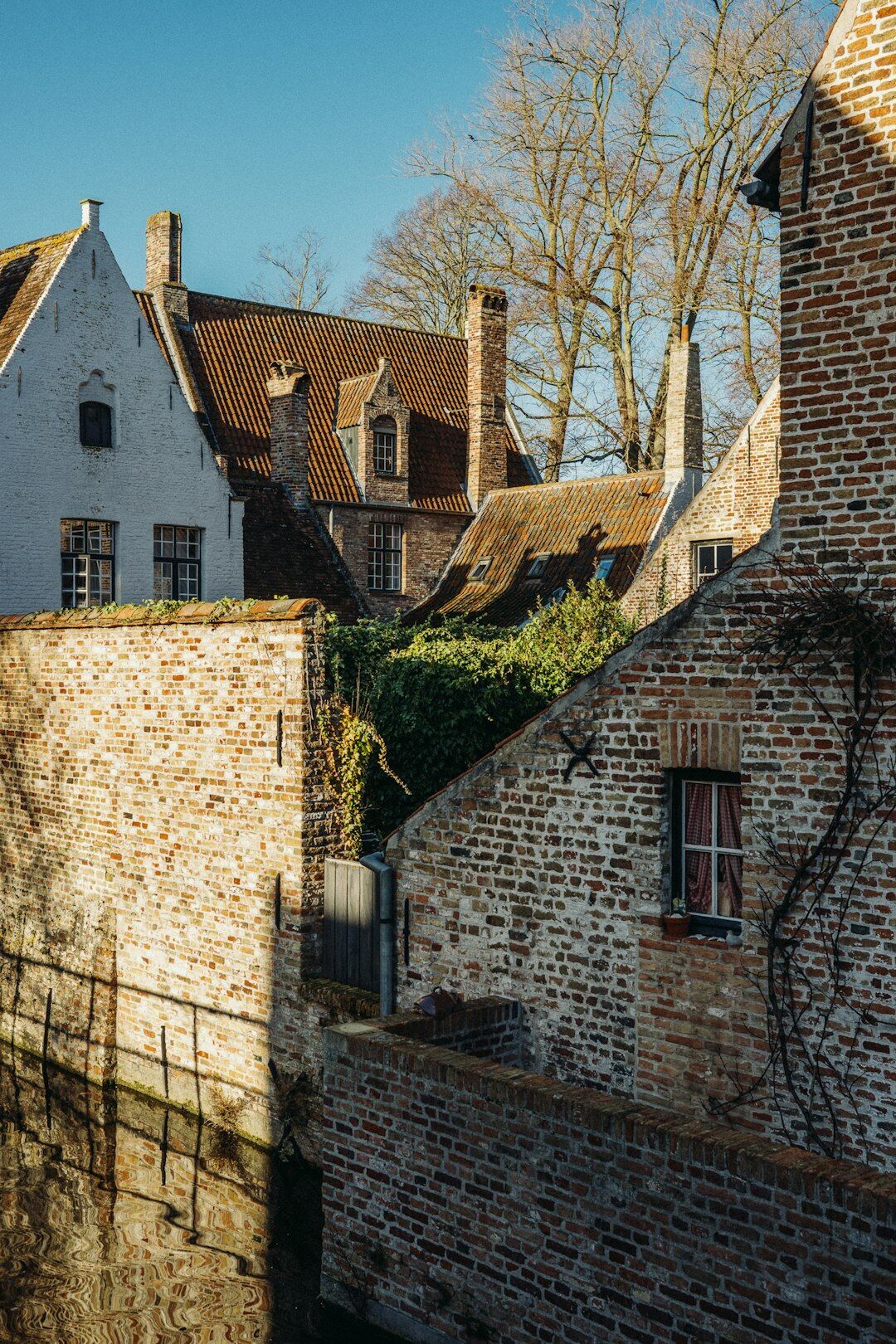 Medieval canal houses reflected in the water in Bruges